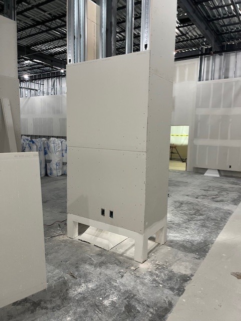 Cleanroom wall system build-out with metal framing and sealed panel construction