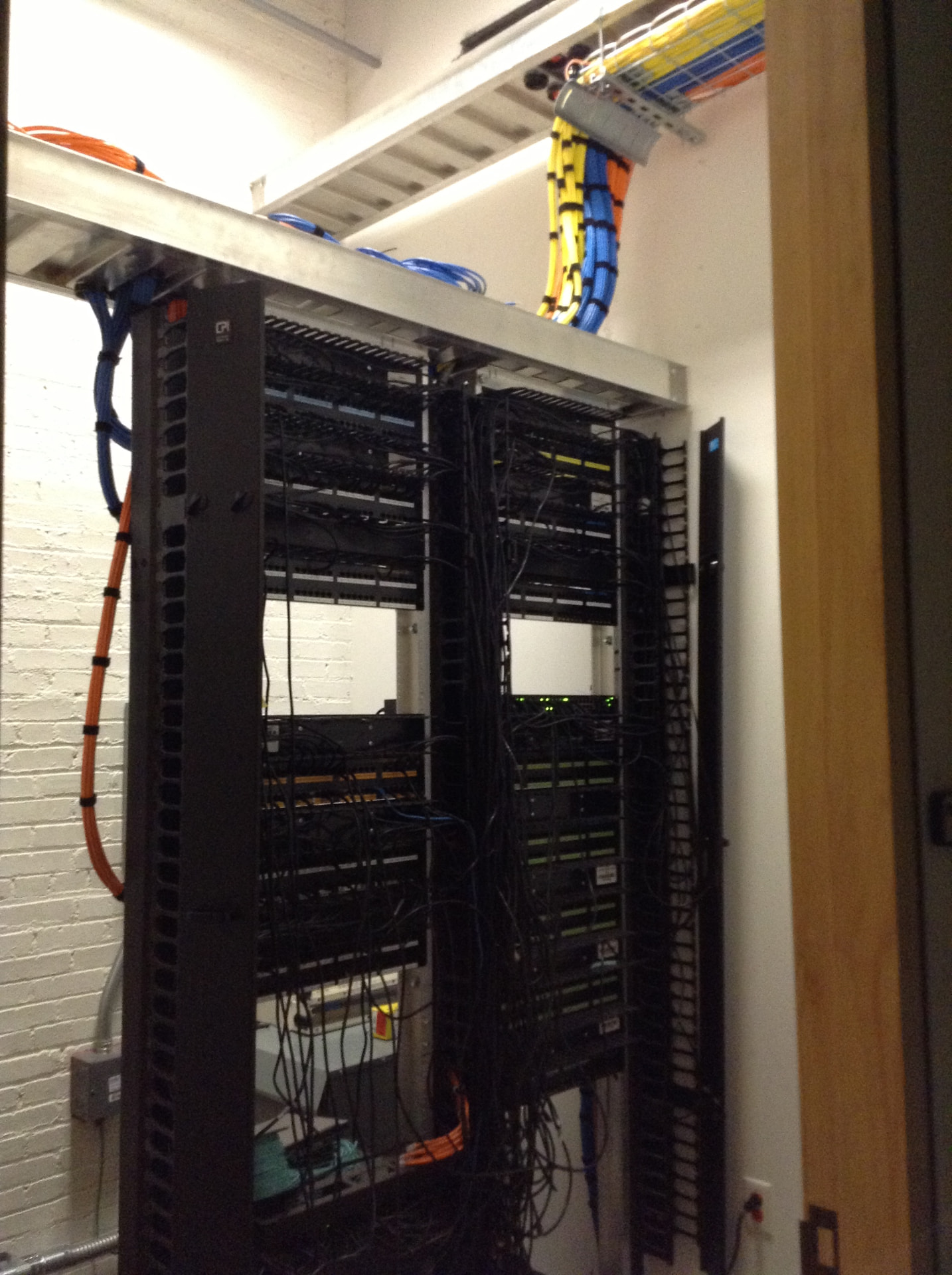 Structured cabling rack with dressed copper and fiber runs in an MDF room