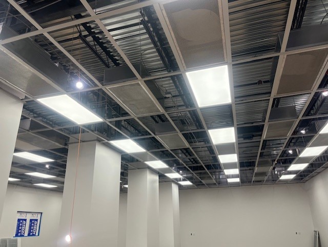 Cleanroom ceiling grid with sealed panels and integrated lighting during installation