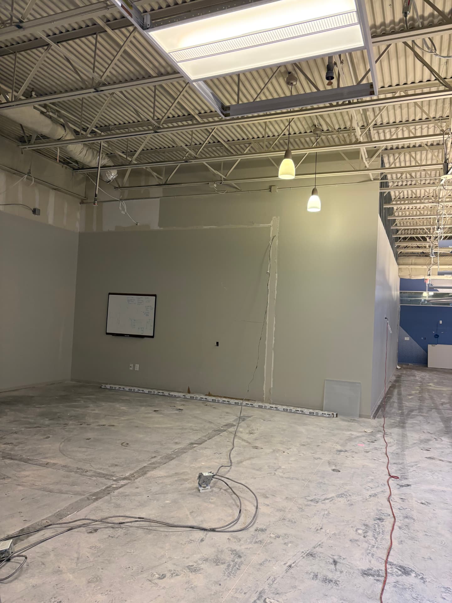 Finished painted interior space with new ceiling grid and lighting ready for turnover